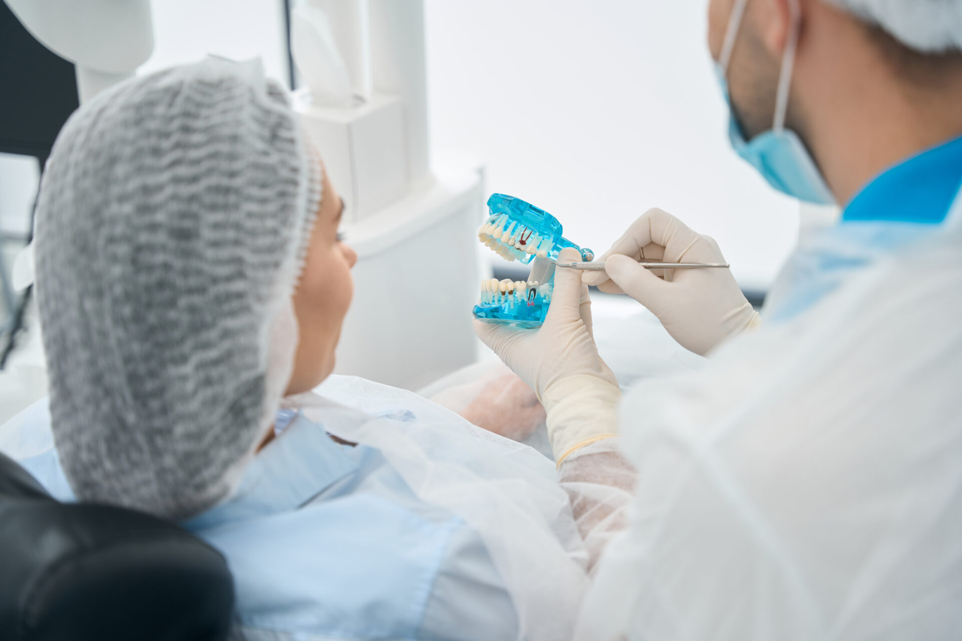 Patient examines the model with dental implants